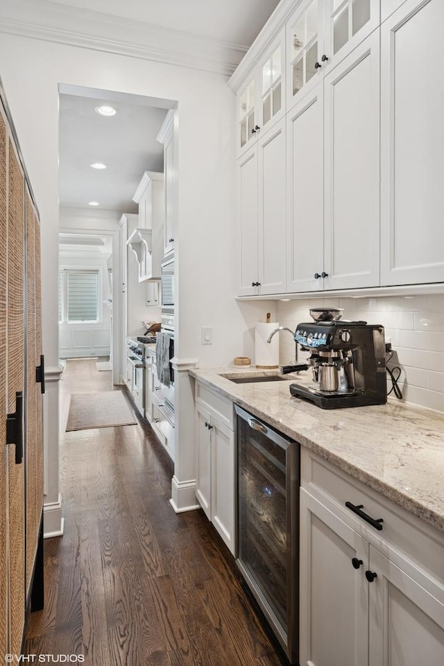 1931 W Barry Ave, Chicago, IL 60657 - bar with wine cooler, dark wood-style floors, a sink, ornamental molding, and wall oven