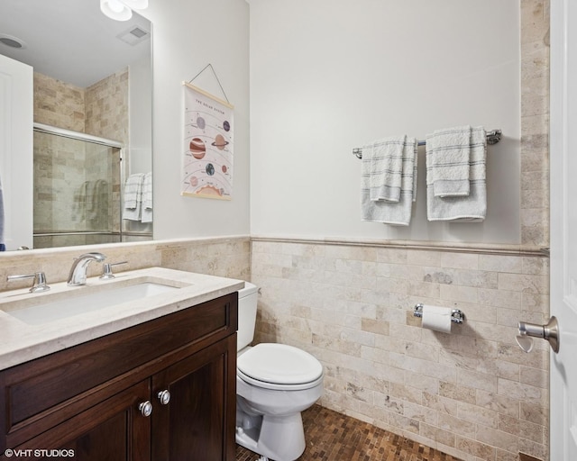 1931 W Barry Ave, Chicago, IL 60657 - full bathroom with toilet, a shower stall, vanity, tile walls, and wainscoting