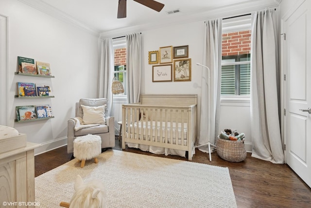 1931 W Barry Ave, Chicago, IL 60657 - bedroom with a crib, multiple windows, crown molding, dark wood-type flooring, and a ceiling fan