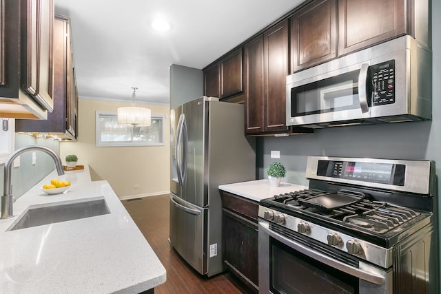 2317 Forest Ave, North Riverside, IL 60546 - kitchen featuring stainless steel appliances, a sink, dark brown cabinets, dark wood-style floors, and a chandelier