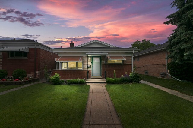 2317 Forest Ave, North Riverside, IL 60546 - view of front of home featuring brick siding, a lawn, and a chimney