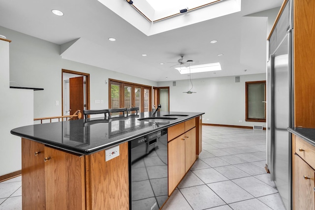 6801 N Lexington Ln, Niles, IL 60714 - kitchen featuring a sink, a skylight, dishwasher, a center island with sink, and a ceiling fan