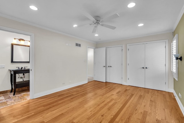 6801 N Lexington Ln, Niles, IL 60714 - unfurnished bedroom with two closets, recessed lighting, light wood-style floors, baseboards, and ensuite bath
