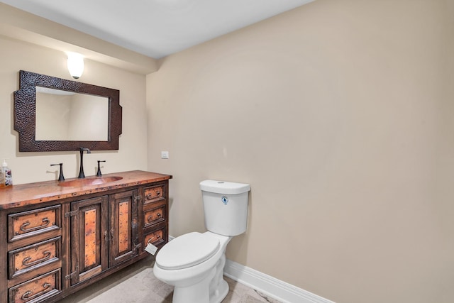 6801 N Lexington Ln, Niles, IL 60714 - bathroom with baseboards, toilet, and vanity
