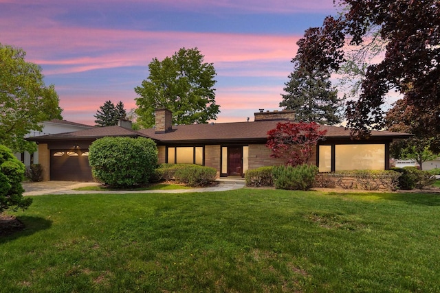 6801 N Lexington Ln, Niles, IL 60714 - view of front of home featuring a garage, a front yard, concrete driveway, and a chimney