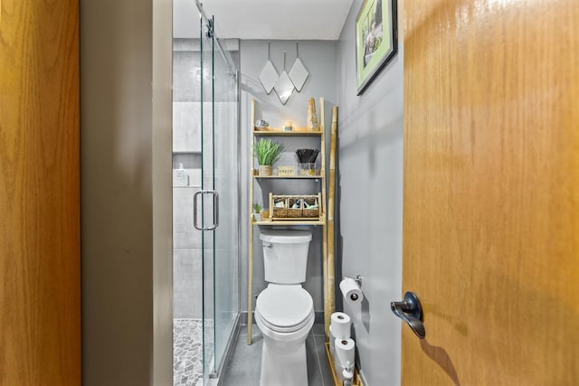 bathroom with toilet and a stall shower