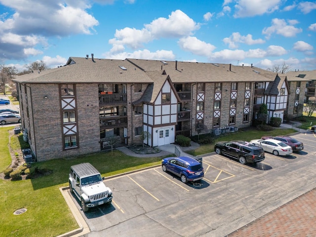 view of building exterior featuring uncovered parking