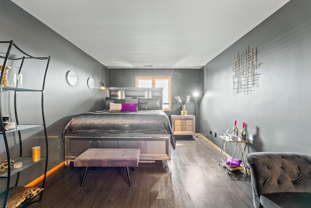 bedroom featuring wood finished floors and baseboards