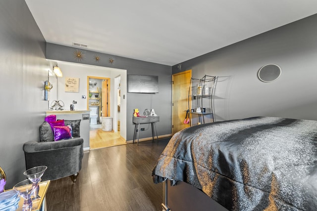 bedroom featuring wood finished floors and baseboards