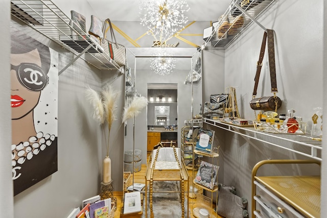 walk in closet featuring a chandelier