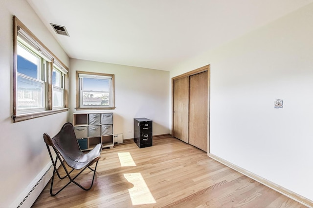 929 N Delphia Ave, Park Ridge, IL 60068 - sitting room featuring baseboard heating, a baseboard radiator, light wood-type flooring, and baseboards