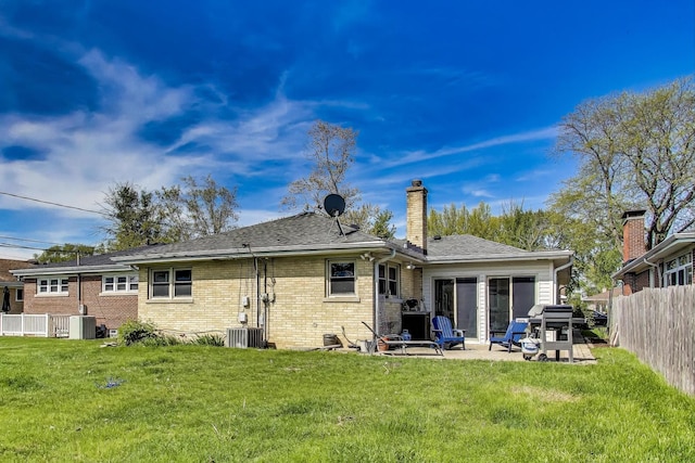929 N Delphia Ave, Park Ridge, IL 60068 - rear view of house featuring brick siding, central AC, a chimney, and a patio