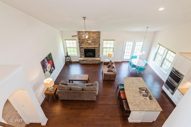 3815 Ridge Pointe Dr, Geneva, IL 60134 - living room featuring dark wood-style floors, a stone fireplace, recessed lighting, and a ceiling fan
