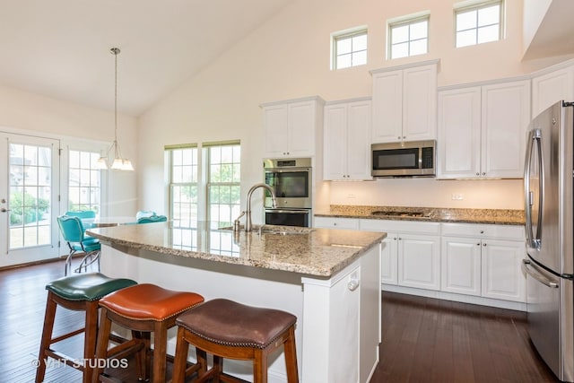 3815 Ridge Pointe Dr, Geneva, IL 60134 - kitchen with appliances with stainless steel finishes, high vaulted ceiling, white cabinetry, dark wood-style flooring, and a breakfast bar