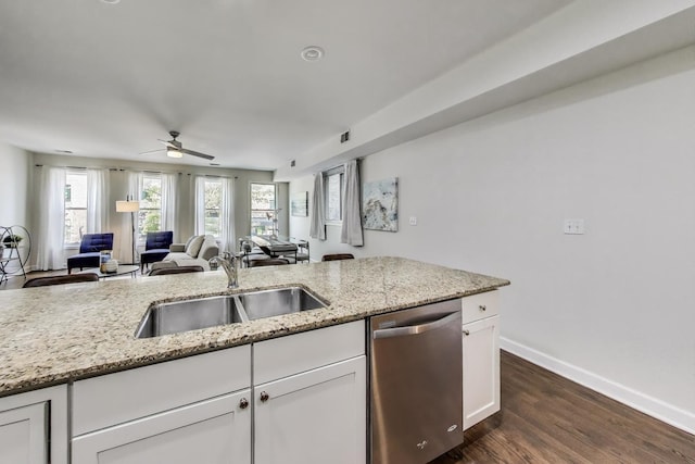 2303 W Chicago Ave Unit 2, Chicago, IL 60622 - kitchen with stainless steel dishwasher, a sink, ceiling fan, white cabinets, and light stone counters