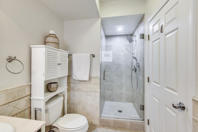2303 W Chicago Ave Unit 2, Chicago, IL 60622 - full bathroom with tile walls, a stall shower, toilet, vanity, and a wainscoted wall