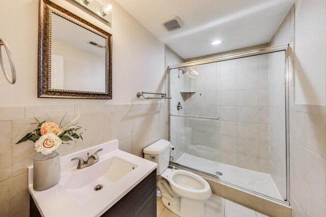 2303 W Chicago Ave Unit 2, Chicago, IL 60622 - bathroom with tile walls, vanity, a stall shower, and toilet