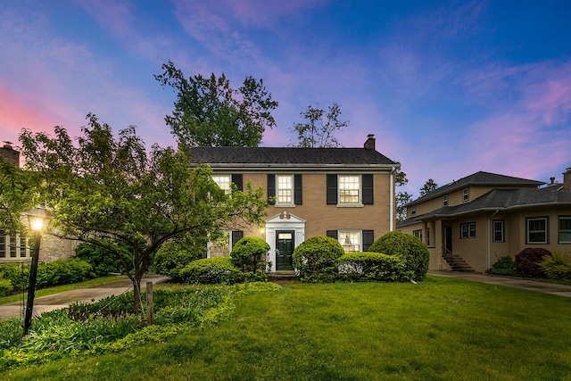 317 Blackhawk Rd, Riverside, IL 60546 - colonial house featuring a chimney and a front lawn