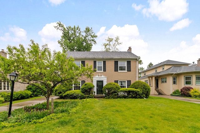 317 Blackhawk Rd, Riverside, IL 60546 - colonial inspired home featuring a front yard and a chimney
