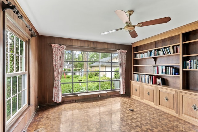 317 Blackhawk Rd, Riverside, IL 60546 - unfurnished room featuring wood walls, a ceiling fan, and plenty of natural light