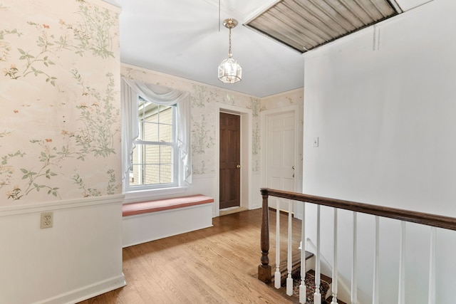 317 Blackhawk Rd, Riverside, IL 60546 - corridor featuring wallpapered walls, wainscoting, wood finished floors, and a chandelier