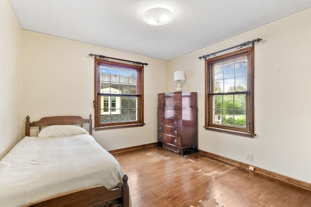317 Blackhawk Rd, Riverside, IL 60546 - bedroom with multiple windows, wood finished floors, and baseboards