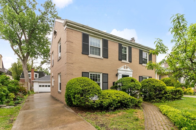 317 Blackhawk Rd, Riverside, IL 60546 - colonial home featuring a detached garage, brick siding, and a chimney