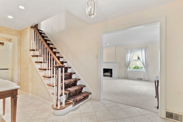 317 Blackhawk Rd, Riverside, IL 60546 - staircase with a fireplace, carpet flooring, tile patterned floors, recessed lighting, and baseboards