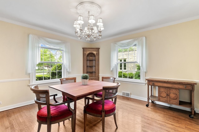 317 Blackhawk Rd, Riverside, IL 60546 - dining room featuring a chandelier, light wood-style flooring, ornamental molding, and baseboards