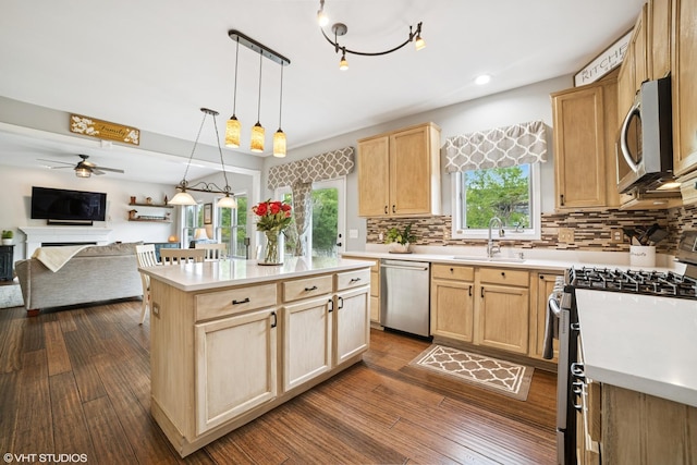 39W326 W Mallory Dr, Geneva, IL 60134 - kitchen with stainless steel appliances, light brown cabinets, a sink, open floor plan, and light countertops