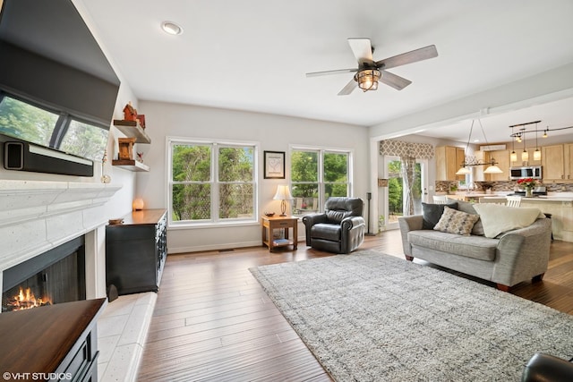 39W326 W Mallory Dr, Geneva, IL 60134 - living room with a lit fireplace, healthy amount of natural light, a ceiling fan, light wood-type flooring, and recessed lighting