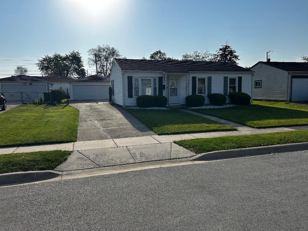 411 Kenyon Ave, Romeoville, IL 60446 - ranch-style home with a front lawn and a detached garage