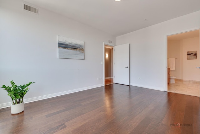 565 W Quincy St Unit 1206, Chicago, IL 60661 - unfurnished bedroom featuring wood finished floors, baseboards, and connected bathroom