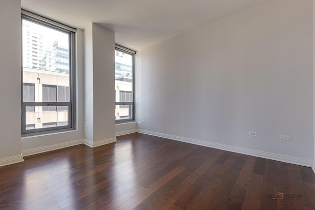 565 W Quincy St Unit 1206, Chicago, IL 60661 - spare room featuring dark wood-style flooring and baseboards