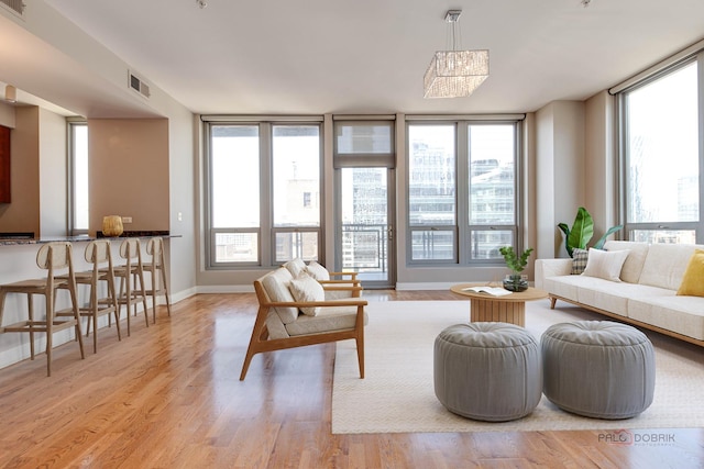 565 W Quincy St Unit 1206, Chicago, IL 60661 - living area featuring wood finished floors, a chandelier, and baseboards