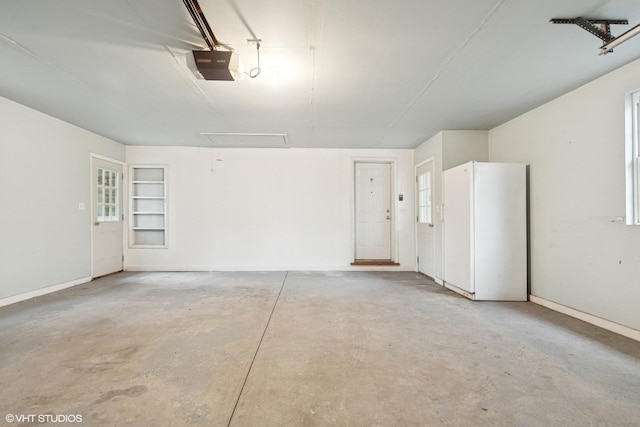 1092 Aberdeen Ln, Mundelein, IL 60060 - garage featuring freestanding refrigerator, a garage door opener, and baseboards
