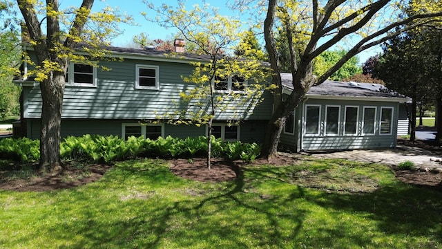 1092 Aberdeen Ln, Mundelein, IL 60060 - rear view of house with a chimney, a yard, and a patio area