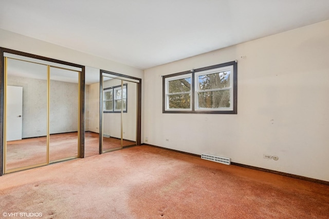 1092 Aberdeen Ln, Mundelein, IL 60060 - unfurnished bedroom with multiple closets, carpet, and baseboards