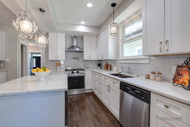 842 Mapleton Ave, Oak Park, IL 60302 - kitchen with stainless steel appliances, wall chimney exhaust hood, a sink, a chandelier, and white cabinets