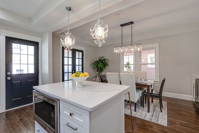 842 Mapleton Ave, Oak Park, IL 60302 - kitchen featuring stainless steel microwave, a chandelier, dark wood finished floors, a kitchen island, and a raised ceiling