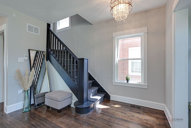 842 Mapleton Ave, Oak Park, IL 60302 - stairs featuring wood finished floors, baseboards, and a chandelier