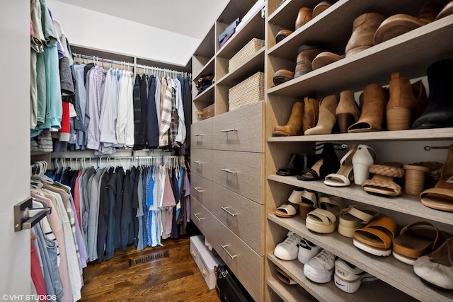walk in closet featuring dark wood-type flooring