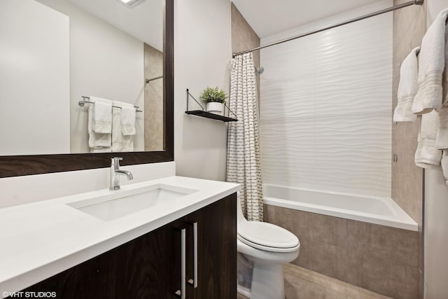 bathroom with tiled shower / bath combo, toilet, vanity, and tile patterned floors