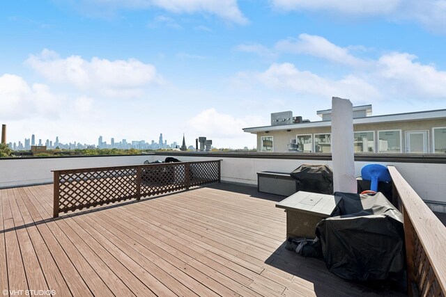 wooden deck featuring a view of skyline