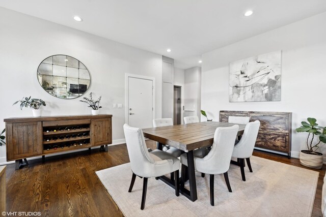 dining room with dark wood-type flooring, recessed lighting, and baseboards