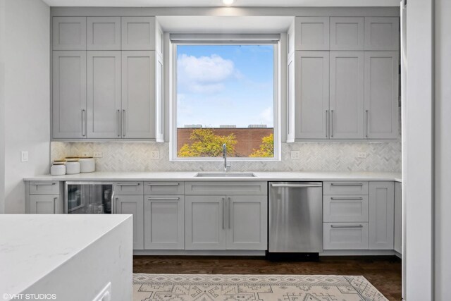 kitchen with dishwasher, a sink, wine cooler, and gray cabinetry