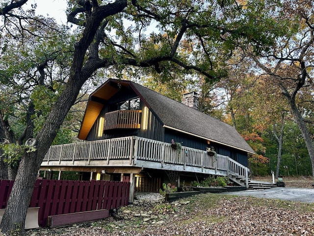 10081 Haas Rd, Rockton, IL 61072 - view of front of property featuring a shingled roof, a chimney, and a deck