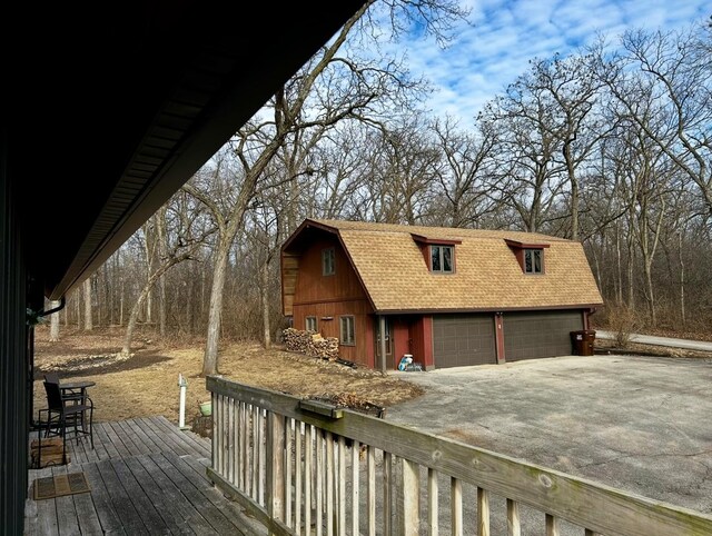 10081 Haas Rd, Rockton, IL 61072 - deck with an outdoor structure, concrete driveway, a garage, and a barn