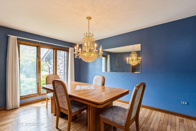 38695 N Shagbark Ln, Wadsworth, IL 60083 - dining area featuring a chandelier, baseboards, and hardwood / wood-style flooring