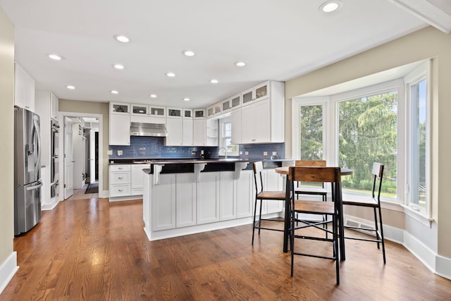 2215 Barger Ct, Wheaton, IL 60189 - kitchen with appliances with stainless steel finishes, under cabinet range hood, backsplash, glass insert cabinets, and recessed lighting